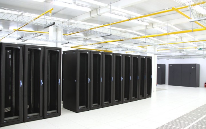 Machine room: closed cabinets in rows, a dedicated cold aisle
